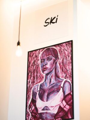 Big expressive portrait of singer Angèle with colourful pink oil paper
